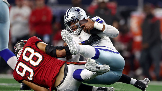 ARLINGTON, TEXAS - SEPTEMBER 11: Anthony Nelson #98 of the Tampa Bay Buccaneers sacks Dak Prescott #4 of the Dallas Cowboys during the second half at AT&T Stadium on September 11, 2022 in Arlington, Texas.