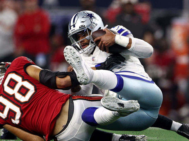 ARLINGTON, TEXAS - SEPTEMBER 11: Anthony Nelson #98 of the Tampa Bay Buccaneers sacks Dak Prescott #4 of the Dallas Cowboys during the second half at AT&T Stadium on September 11, 2022 in Arlington, Texas.