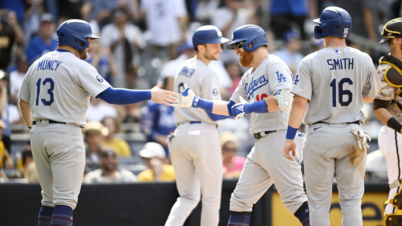 SAN DIEGO, CA - SEPTEMBER 11: Justin Turner #10 of the Los Angeles Dodgers (R) is congratulated by Max Muncy #13 after he hit a grand slam during the seventh inning of a baseball game against the San Diego Padres September 11, 2022 at Petco Park in San Diego, California.