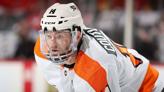 NEWARK, NEW JERSEY - DECEMBER 08: Sean Couturier #14 of the Philadelphia Flyers waits for the puck to drop against the New Jersey Devils during the first period at Prudential Center on December 08, 2021 in Newark, New Jersey. Tonight the New Jersey Devils are wearing their newly designed third jersey.