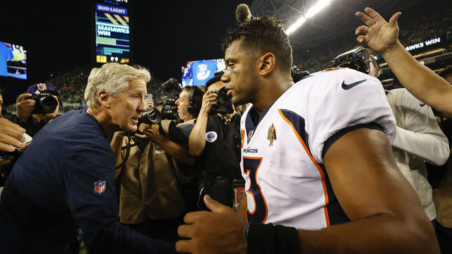 SEATTLE, WASHINGTON - SEPTEMBER 12: Head coach Pete Carroll of the Seattle Seahawks (L) and Russell Wilson #3 of the Denver Broncos shake hands after the Seahawks defeated the Broncos 17-16 at Lumen Field on September 12, 2022 in Seattle, Washington.