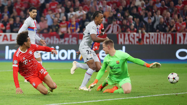 MUNICH, GERMANY - SEPTEMBER 13: Leroy Sane of Bayern Munich scores their side's second goal as Marc-Andre ter Stegen of FC Barcelona attempts to make a save during the UEFA Champions League group C match between FC Bayern München and FC Barcelona at Allianz Arena on September 13, 2022 in Munich, Germany.