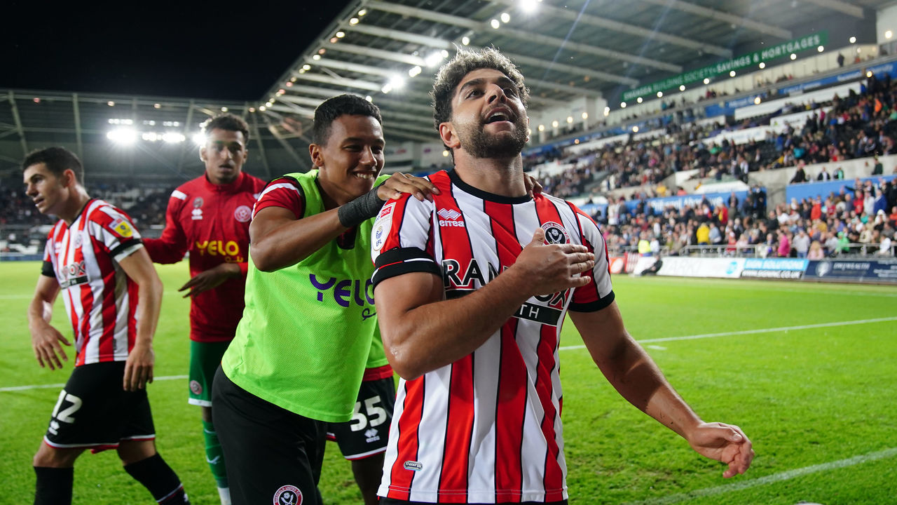 Sheffield United's Reda Khadra celebrates scoring their side's first goal of the game with team-mates during the Sky Bet Championship match at the Swansea.com Stadium, Swansea. Picture date: Tuesday September 13, 2022.