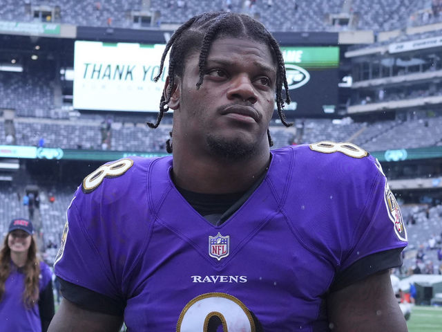 Lamar Jackson of the Baltimore Ravens walks off of the field after