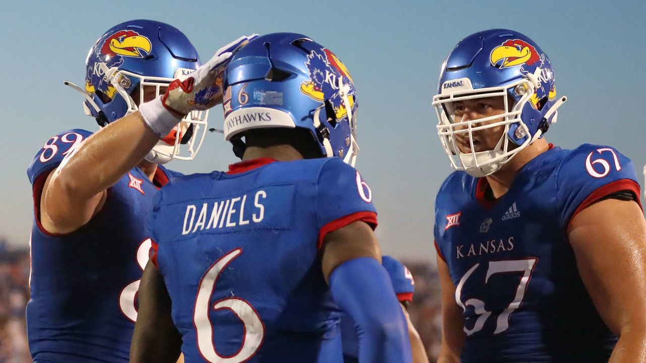 LAWRENCE, KS - SEPTEMBER 02: Kansas Jayhawks quarterback Jalon Daniels (6) is congratulated by offensive lineman Dominick Puni (67) after an 11-yard touchdown run in the second quarter of a college football game between the Tennessee Tech Golden Eagles and Kansas Jayhawks on September 2, 2022 at Memorial Stadium in Lawrence, KS. Photo by Scott Winters/Icon Sportswire via Getty Images)