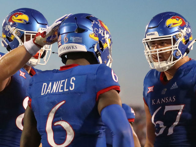 LAWRENCE, KS - SEPTEMBER 02: Kansas Jayhawks quarterback Jalon Daniels (6) is congratulated by offensive lineman Dominick Puni (67) after an 11-yard touchdown run in the second quarter of a college football game between the Tennessee Tech Golden Eagles and Kansas Jayhawks on September 2, 2022 at Memorial Stadium in Lawrence, KS. Photo by Scott Winters/Icon Sportswire via Getty Images)
