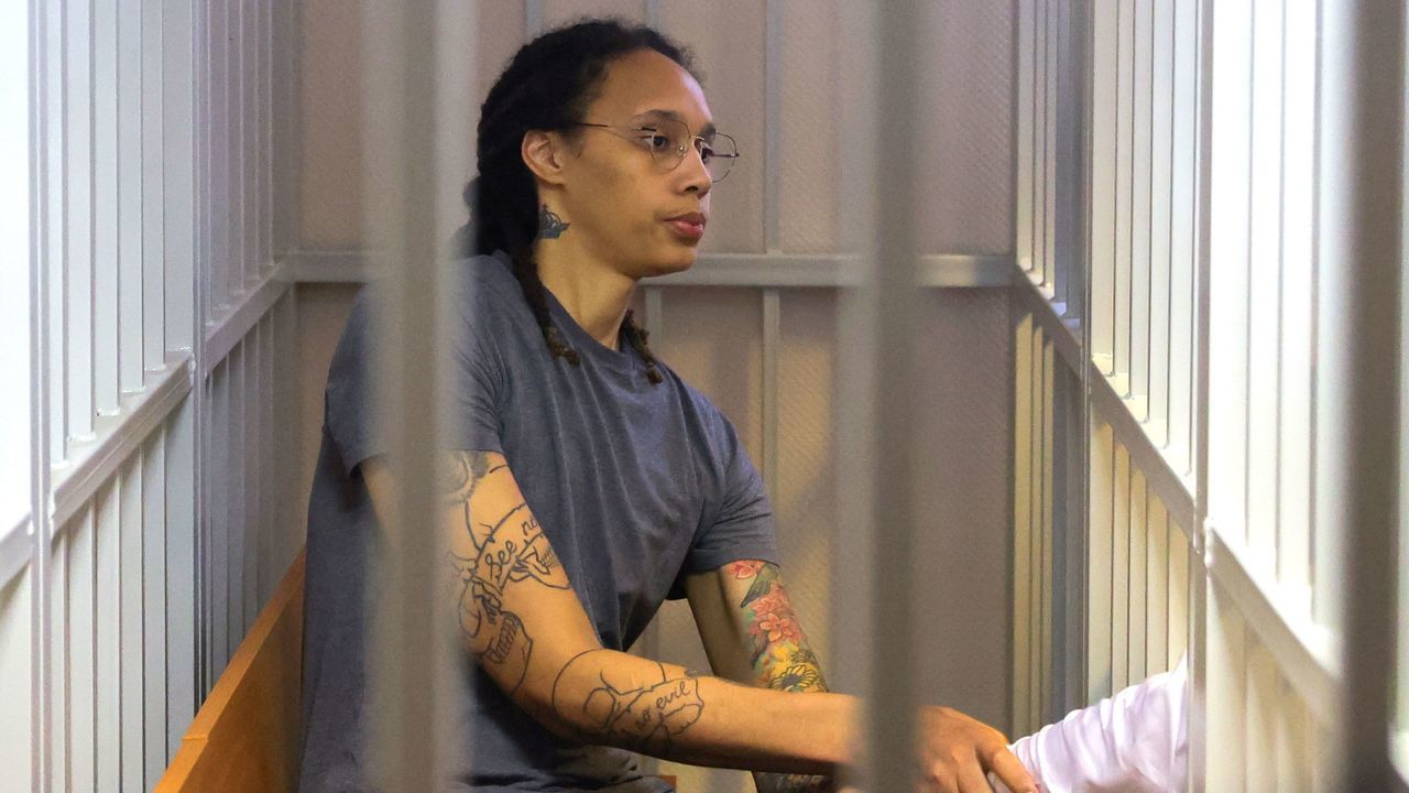 US Women's National Basketball Association (WNBA) basketball player Brittney Griner, who was detained at Moscow's Sheremetyevo airport and later charged with illegal possession of cannabis, sits inside a defendants' cage after the court's verdict during a hearing in Khimki outside Moscow, on August 4, 2022. - A Russian court found Griner guilty of smuggling and storing narcotics after prosecutors requested a sentence of nine and a half years in jail for the athlete.