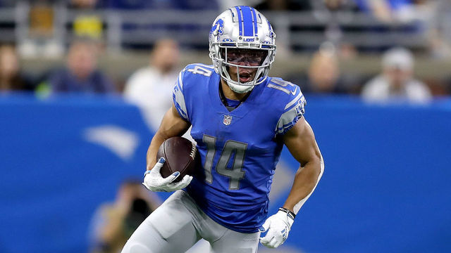 DETROIT, MICHIGAN - DECEMBER 19: Amon-Ra St. Brown #14 of the Detroit Lions runs with the ball against against the Arizona Cardinals in the first half at Ford Field on December 19, 2021 in Detroit, Michigan.