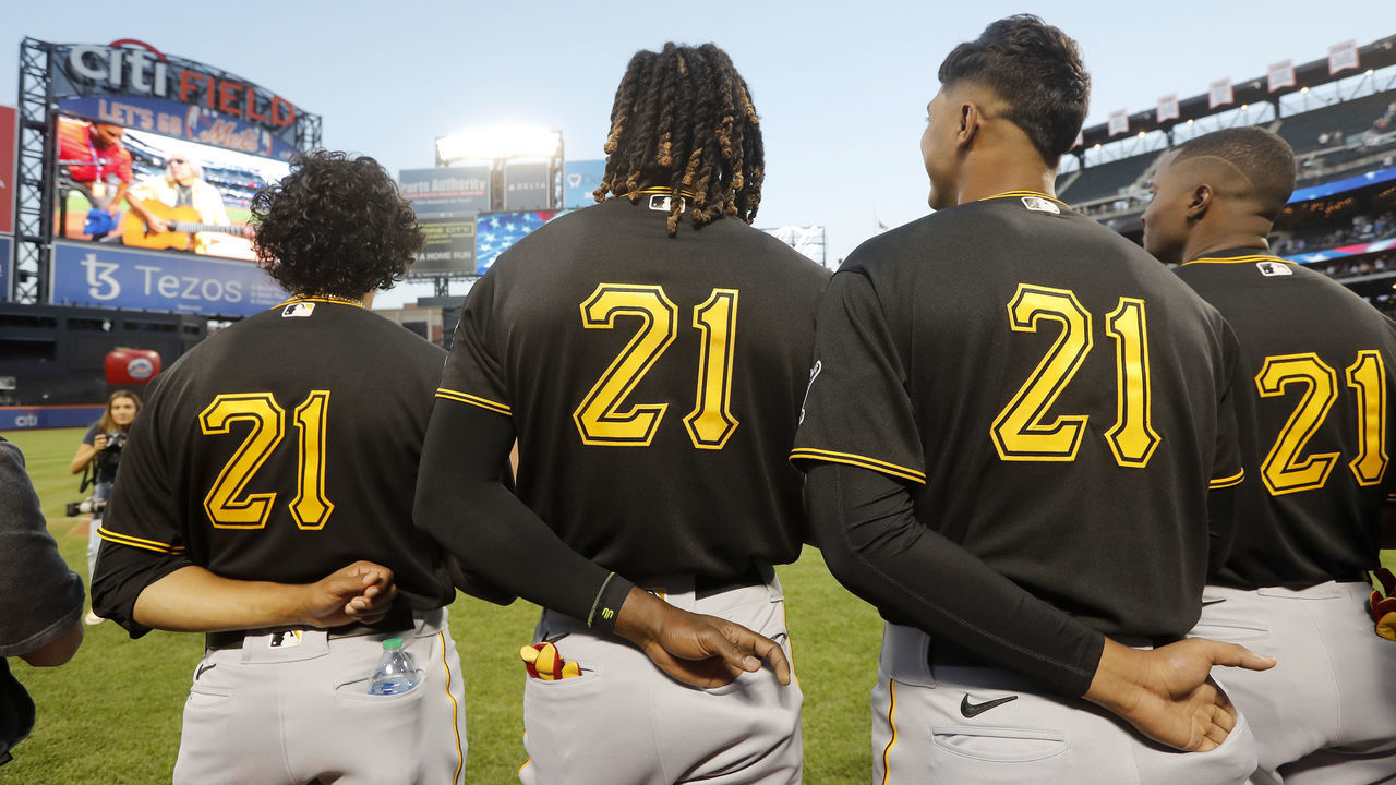 NEW YORK, NEW YORK - SEPTEMBER 15: The Pittsburgh Pirates stand during the national anthem before a game against the New York Mets at Citi Field on September 15, 2022 in New York City. Players are wearing number 21 in honor of Roberto Clemente Day.