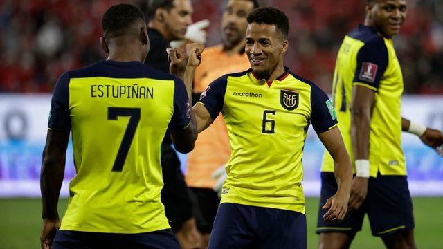 Ecuador's Pervis Estupinan (L) celebrates with teammate Byron Castillo after scoring against Chile during their South American qualification football match for the FIFA World Cup Qatar 2022 at the San Carlos de Apoquindo stadium in Santiago, on November 16, 2021.