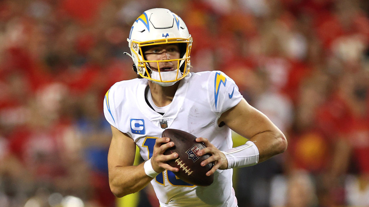 KANSAS CITY, MISSOURI - SEPTEMBER 15: Justin Herbert #10 of the Los Angeles Chargers scrambles with the ball during the fourth quarter against the Kansas City Chiefs at Arrowhead Stadium on September 15, 2022 in Kansas City, Missouri.