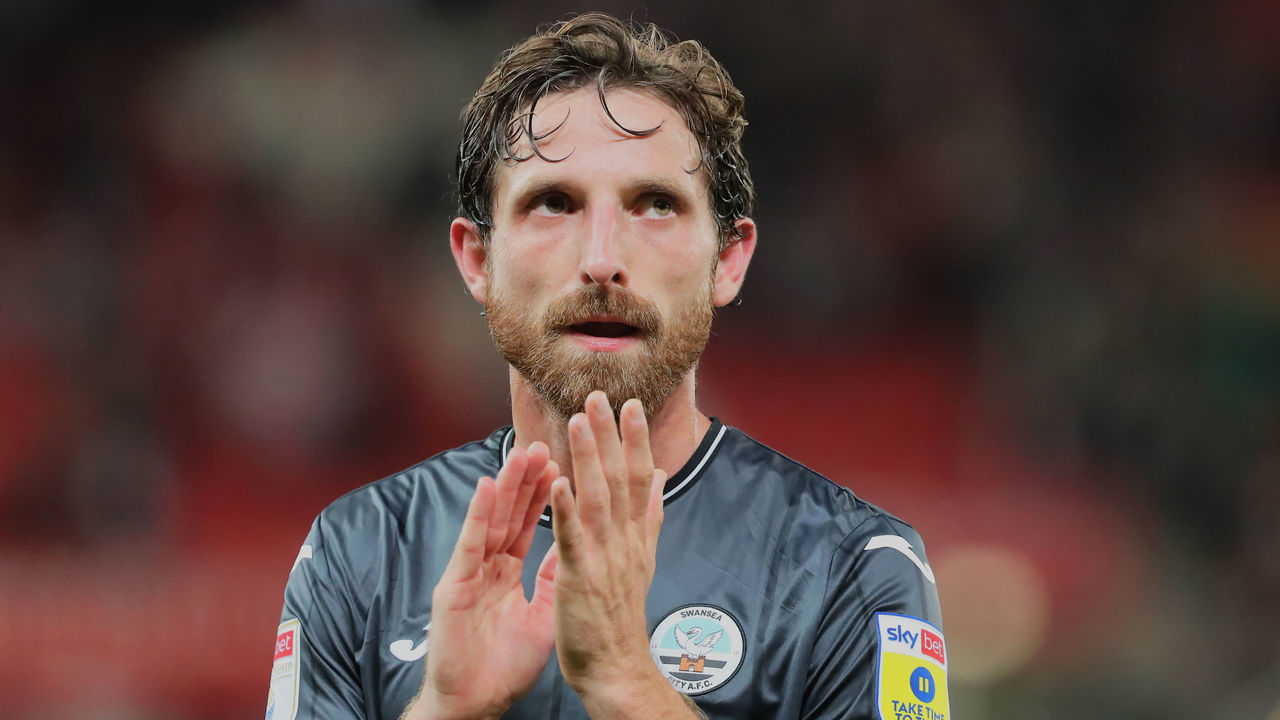 STOKE ON TRENT, ENGLAND - AUGUST 31: Joe Allen of Swansea City thanks away supporters after the final whistle during the Sky Bet Championship match between Stoke City and Swansea City at bet365 Stadium on August 31, 2022 in Stoke on Trent, England.