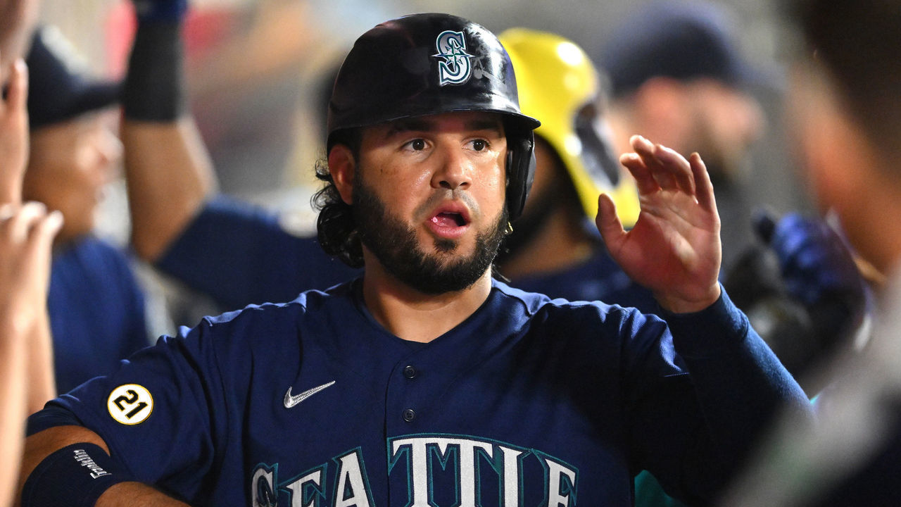 ANAHEIM, CA - SEPTEMBER 16: Eugenio Suarez #28 of the Seattle Mariners is greeted in the dugout after scoring on a two run home run by Carlos Santana #41 in the fourth inning at Angel Stadium of Anaheim on September 16, 2022 in Anaheim, California.