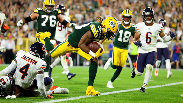 GREEN BAY, WISCONSIN - SEPTEMBER 18: Aaron Jones #33 of the Green Bay Packers scores a touchdown during the second quarter in the game against the Chicago Bears at Lambeau Field on September 18, 2022 in Green Bay, Wisconsin.