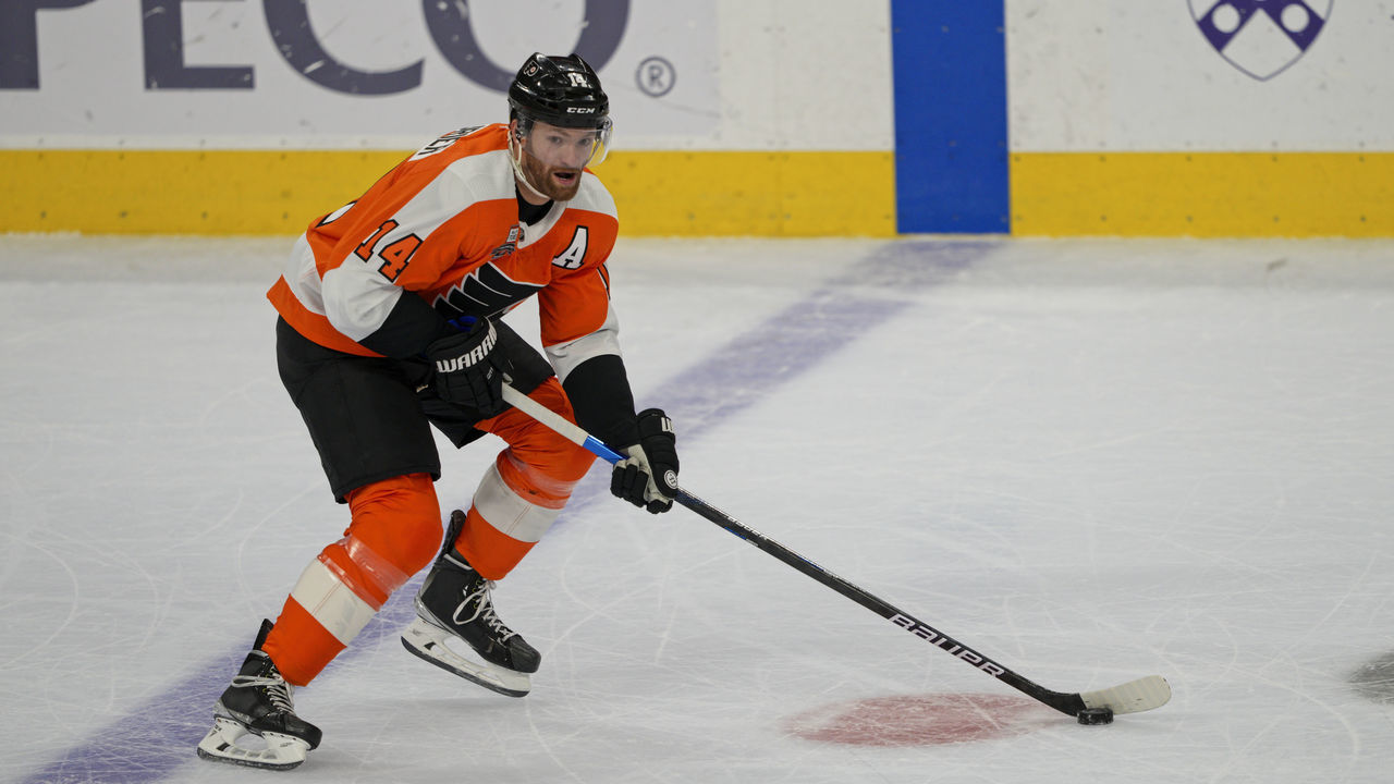 PHILADELPHIA, PA - NOVEMBER 16:Philadelphia Flyers Center Sean Couturier (14) skates with the puck during the game between the Calgary Flames and Philadelphia Flyers on November 16, 2021 at Wells Fargo Center in Philadelphia, PA.