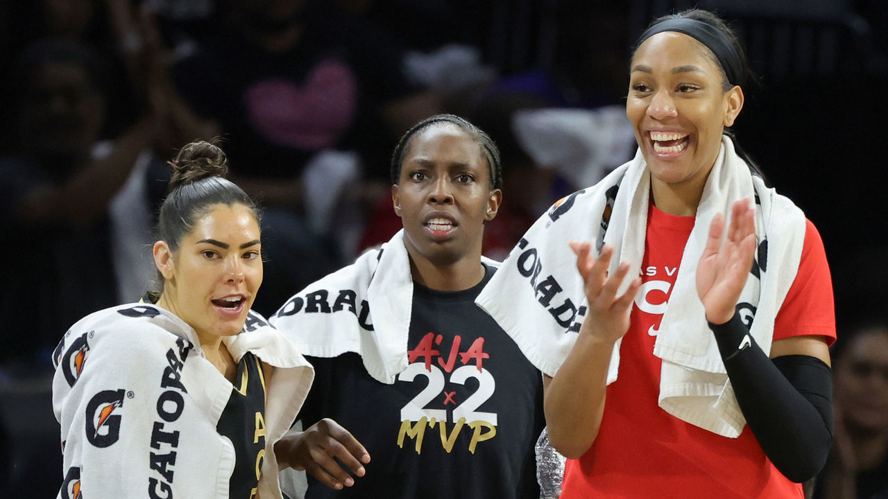 LAS VEGAS, NEVADA - AUGUST 20: (L-R) Kelsey Plum #1, Chelsea Gray #12 and A'ja Wilson #22 of the Las Vegas Aces react after teammate Theresa Plaisance #55 scored against the Phoenix Mercury in the fourth quarter of Game Two of the 2022 WNBA Playoffs first round at Michelob ULTRA Arena on August 20, 2022 in Las Vegas, Nevada. The Aces defeated the Mercury 117-80 to win the series.