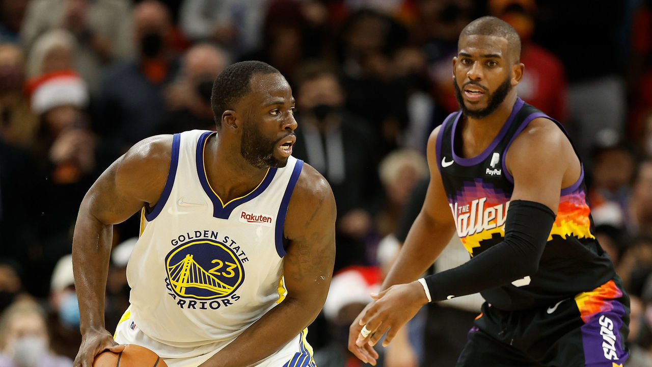 PHOENIX, ARIZONA - DECEMBER 25: Draymond Green #23 of the Golden State Warriors handles the ball against Chris Paul #3 of the Phoenix Suns during the second half of NBA game at Footprint Center on December 25, 2021 in Phoenix, Arizona. The Warriors defeated the Suns 116-107.