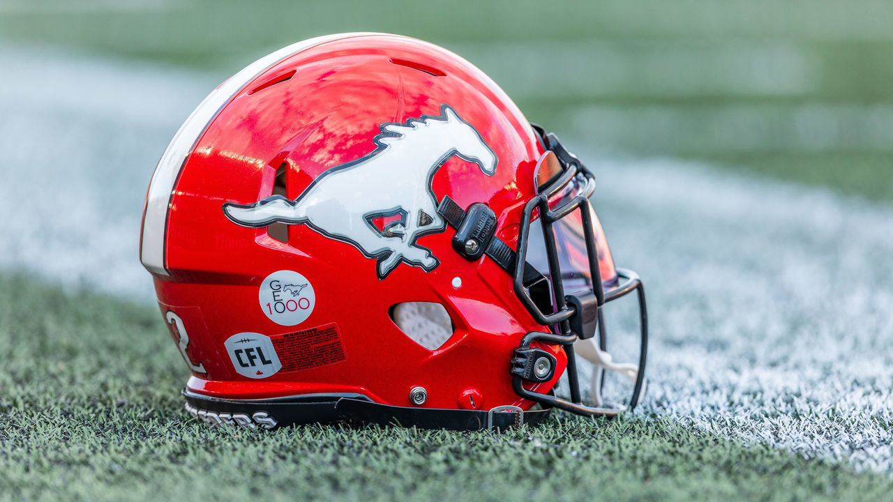 OTTAWA, ON - AUGUST 05: Calgary Stampeders helmet rests on the field during warm-up before Canadian Football League action between the Calgary Stampeders and Ottawa Redblacks on August 5, 2022, at TD Place at Lansdowne Park in Ottawa, ON, Canada.
