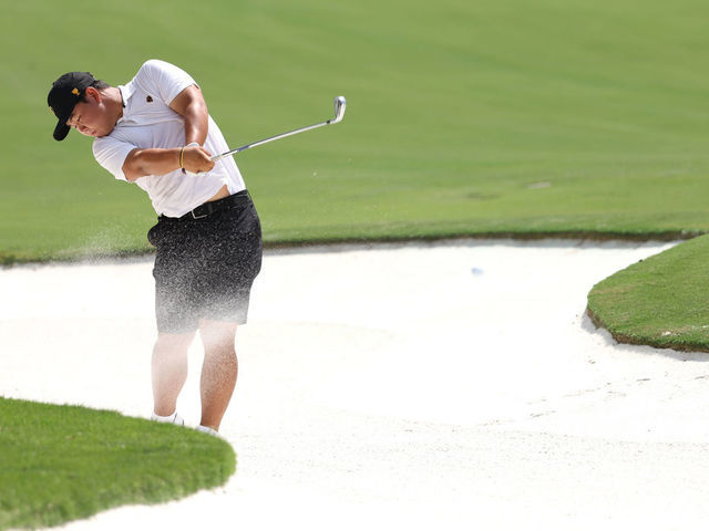 CHARLOTTE, NORTH CAROLINA - SEPTEMBER 19: Tom Kim of South Korea and the International Team plays a shot from a bunker prior to the 2022 Presidents Cup at Quail Hollow Country Club on September 19, 2022 in Charlotte, North Carolina.