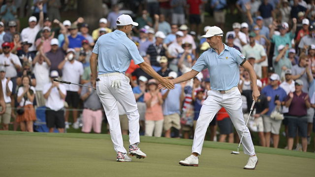 CHARLOTTE, NORTH CAROLINA - SEPTEMBER 22: U.S. Team members Jordan Spieth and Justin Thomas celebrate Justins putt on the 15th hole during the first round of Presidents Cup at Quail Hollow September 22, 2022, in Charlotte, North Carolina.