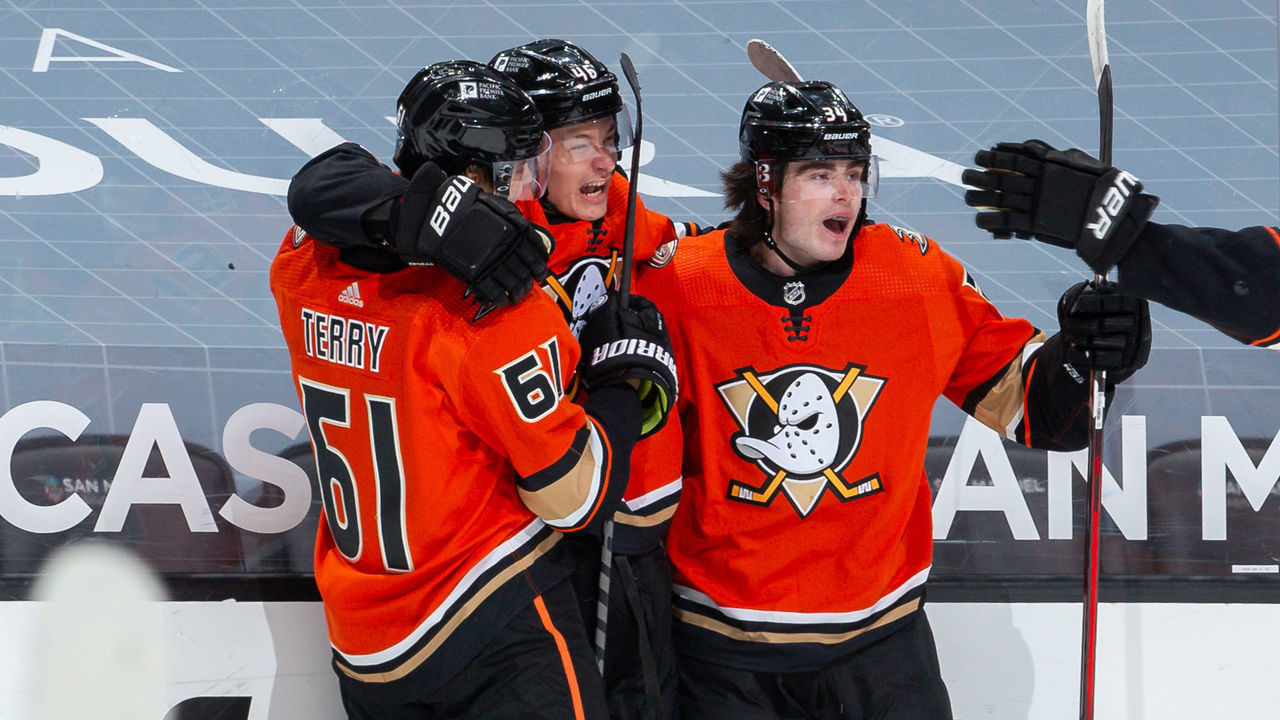ANAHEIM, CA - MARCH 18: Trevor Zegras #46 of the Anaheim Ducks celebrates his second-period goal against the Arizona Coyotes, his first NHL career goal, with Troy Terry #61, Jamie Drysdale #34 and Ben Hutton #7 during the game at Honda Center on March 18, 2021 in Anaheim, California.