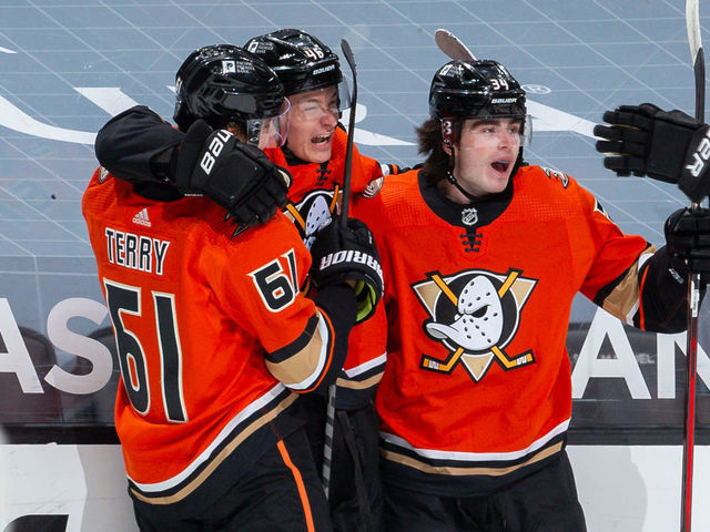 ANAHEIM, CA - MARCH 18: Trevor Zegras #46 of the Anaheim Ducks celebrates his second-period goal against the Arizona Coyotes, his first NHL career goal, with Troy Terry #61, Jamie Drysdale #34 and Ben Hutton #7 during the game at Honda Center on March 18, 2021 in Anaheim, California.