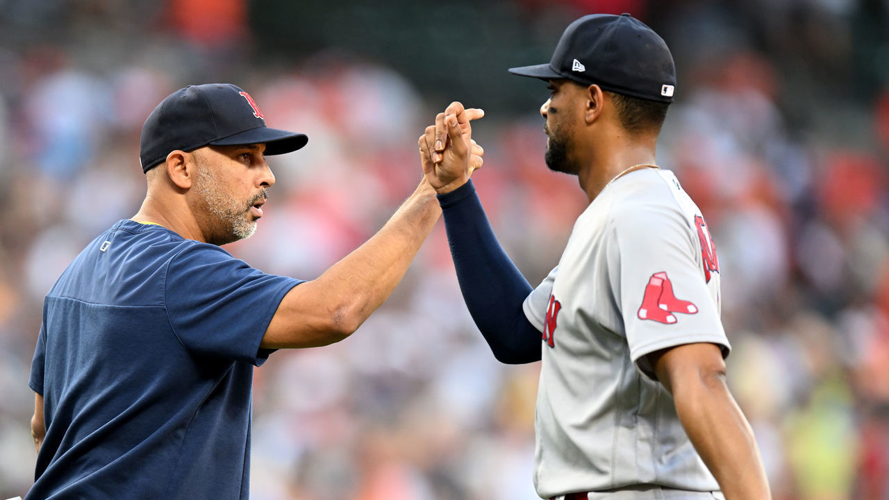 BALTIMORE, MARYLAND - AUGUST 20: Manager Alex Cora #13 of the Boston Red Sox celebrates with Xander Bogaerts #2 after a victory against the Baltimore Orioles at Oriole Park at Camden Yards on August 20, 2022 in Baltimore, Maryland.
