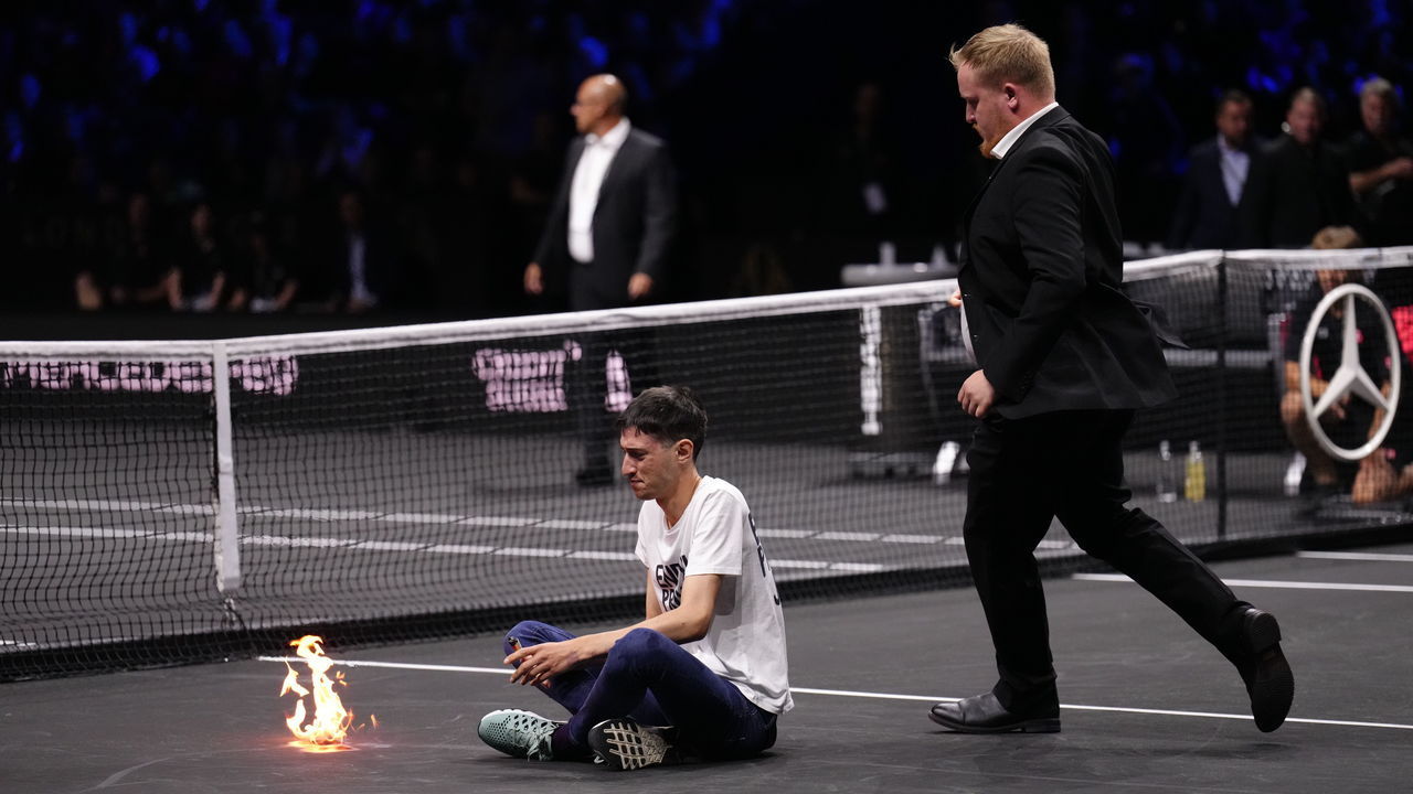 A protester lights a fire on the court on day one of the Laver Cup at the O2 Arena, London. Picture date: Friday September 23, 2022.