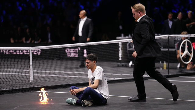 A protester lights a fire on the court on day one of the Laver Cup at the O2 Arena, London. Picture date: Friday September 23, 2022.