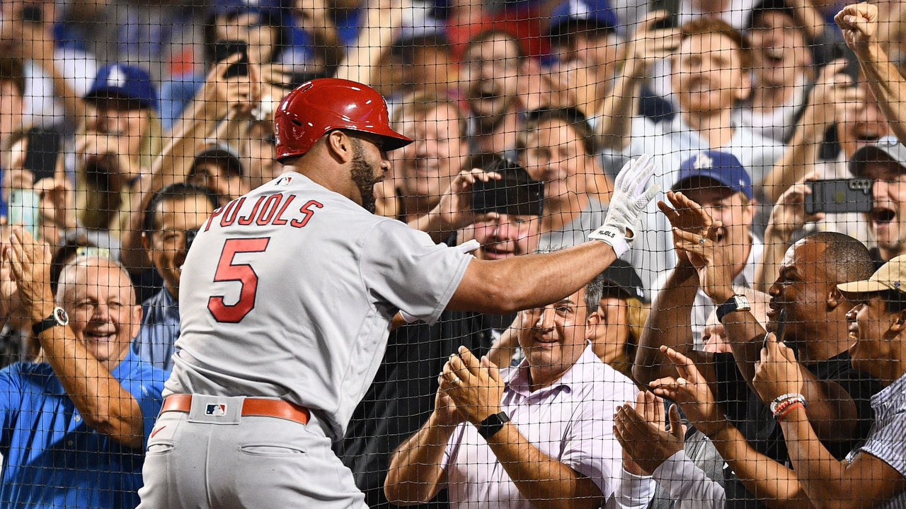 LOS ANGELES, CA - SEPTEMBER 23: St. Louis Cardinals designated hitter Albert Pujols (5) gives former MLB player Adrian Beltre a high five after his career home run number 700 as a three run home run in the 4th inning of the MLB game between the St. Louis Cardinals and the Los Angeles Dodgers on September 23, 2022 at Dodger Stadium in Los Angeles, CA.