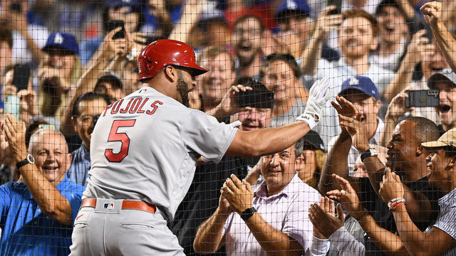 LOS ANGELES, CA - SEPTEMBER 23: St. Louis Cardinals designated hitter Albert Pujols (5) gives former MLB player Adrian Beltre a high five after his career home run number 700 as a three run home run in the 4th inning of the MLB game between the St. Louis Cardinals and the Los Angeles Dodgers on September 23, 2022 at Dodger Stadium in Los Angeles, CA.