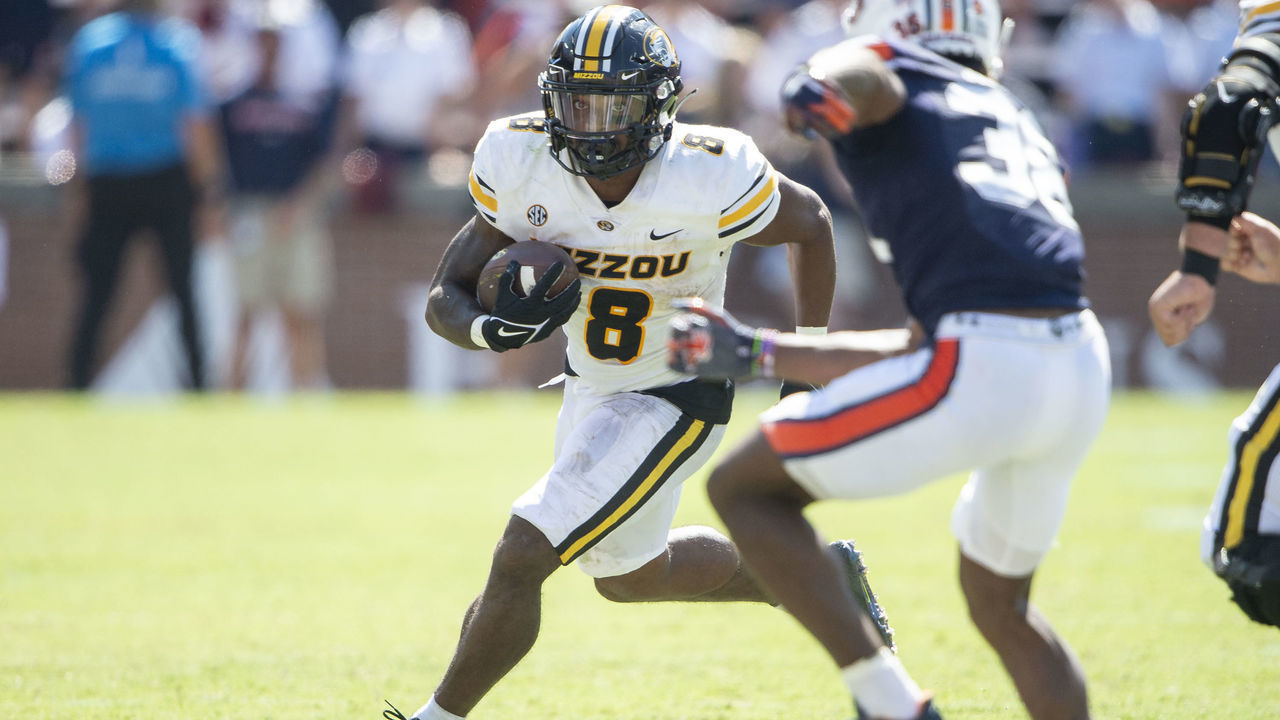 AUBURN, ALABAMA - SEPTEMBER 24: Running back Nathaniel Peat #8 of the Missouri Tigers looks to run the ball by defensive back Greg McConico Jr. #38 of the Auburn Tigers during the second half of play at Jordan-Hare Stadium on September 24, 2022 in Auburn, Alabama.