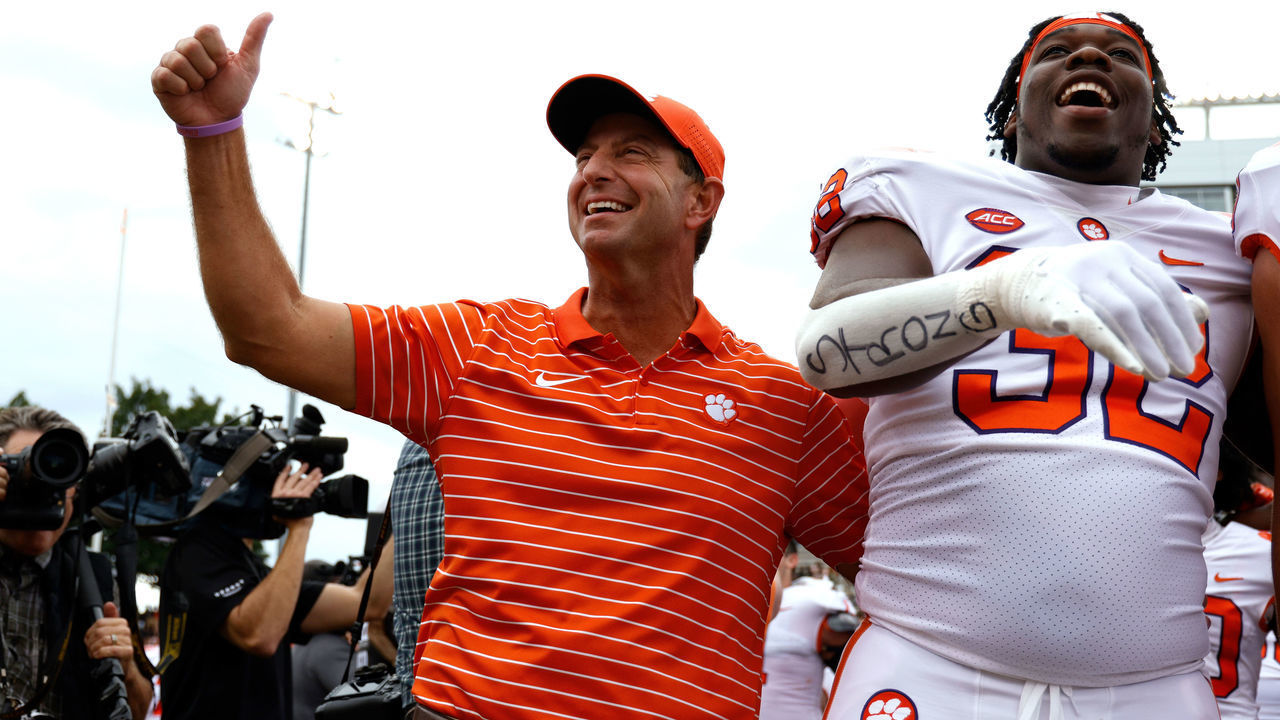 WINSTON-SALEM, NC - SEPTEMBER 24: Head coach Dabo Swinney and Etinosa Reuben #32 of the Clemson Tigers celebrate following their 51-45 double overtime victory against the Wake Forest Demon Deacons at Truist Field on September 24, 2022 in Winston-Salem, North Carolina.