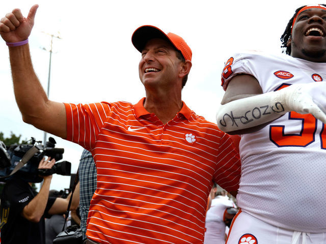 WINSTON-SALEM, NC - SEPTEMBER 24: Head coach Dabo Swinney and Etinosa Reuben #32 of the Clemson Tigers celebrate following their 51-45 double overtime victory against the Wake Forest Demon Deacons at Truist Field on September 24, 2022 in Winston-Salem, North Carolina.