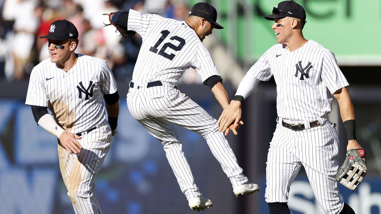 NEW YORK, NEW YORK - SEPTEMBER 24: Harrison Bader #22, Isiah Kiner-Falefa #12, and Aaron Judge #99 of the New York Yankees celebrate during the ninth inning against the Boston Red Sox at Yankee Stadium on September 24, 2022 in the Bronx borough of New York City. The New York Yankees won 7-5.