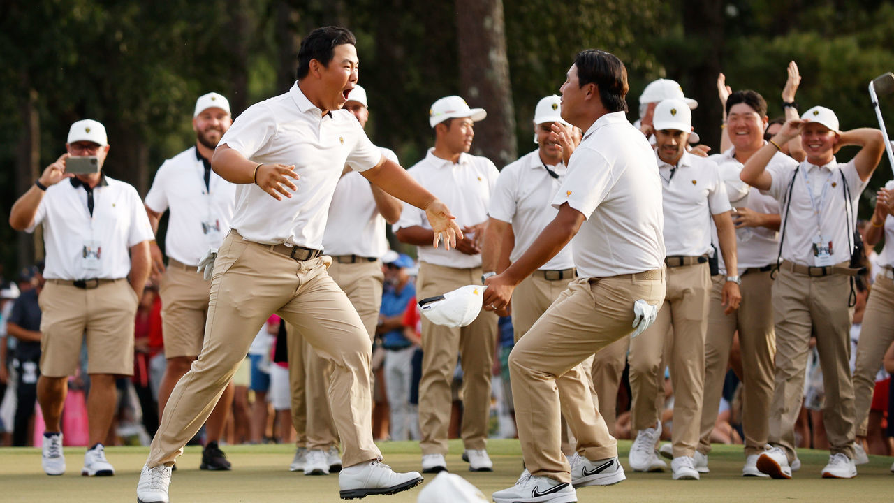 CHARLOTTE, NORTH CAROLINA - SEPTEMBER 24: Tom Kim of South Korea and the International Team celebrates his hole-winning putt to win the match 1 Up with Si Woo Kim of South Korea against Patrick Cantlay and Xander Schauffele of the United States Team during Saturday afternoon four-ball matches on day three of the 2022 Presidents Cup at Quail Hollow Country Club on September 24, 2022 in Charlotte, North Carolina.