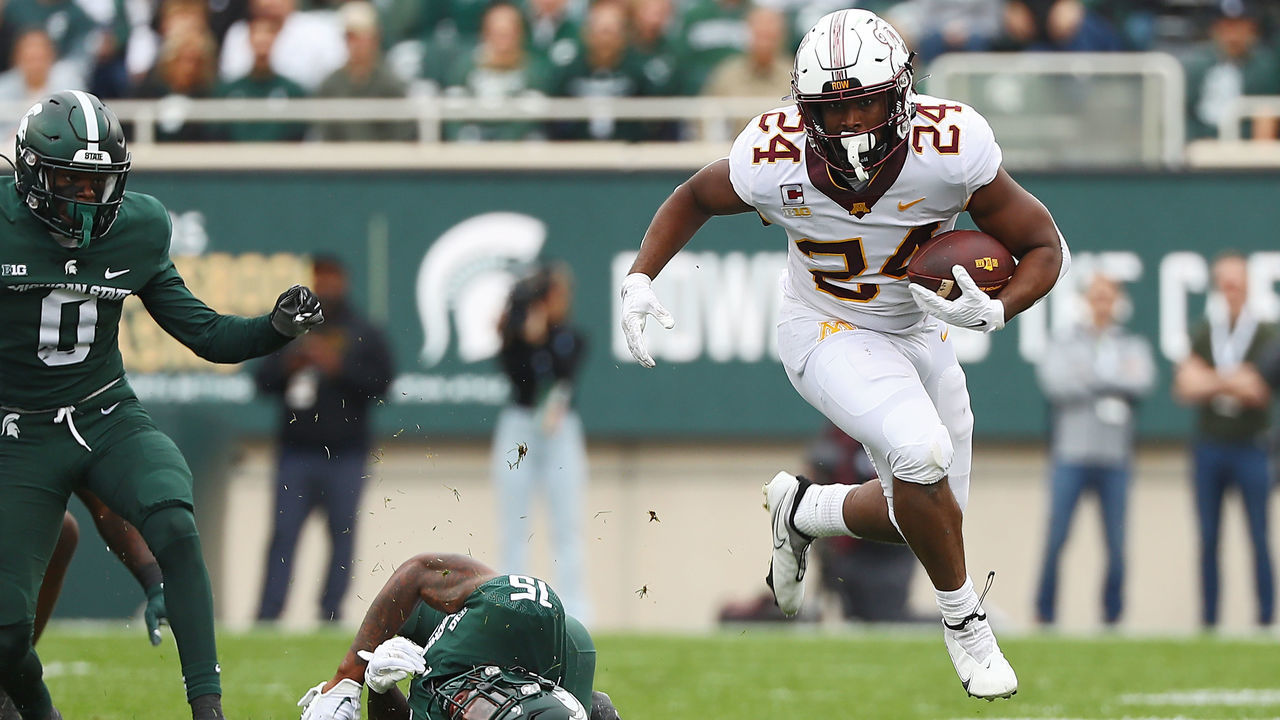 EAST LANSING, MICHIGAN - SEPTEMBER 24: Mohamed Ibrahim #24 of the Minnesota Golden Gophers leaps after avoiding a tackle by Angelo Grose #15 of the Michigan State Spartans in the first half at Spartan Stadium on September 24, 2022 in East Lansing, Michigan.