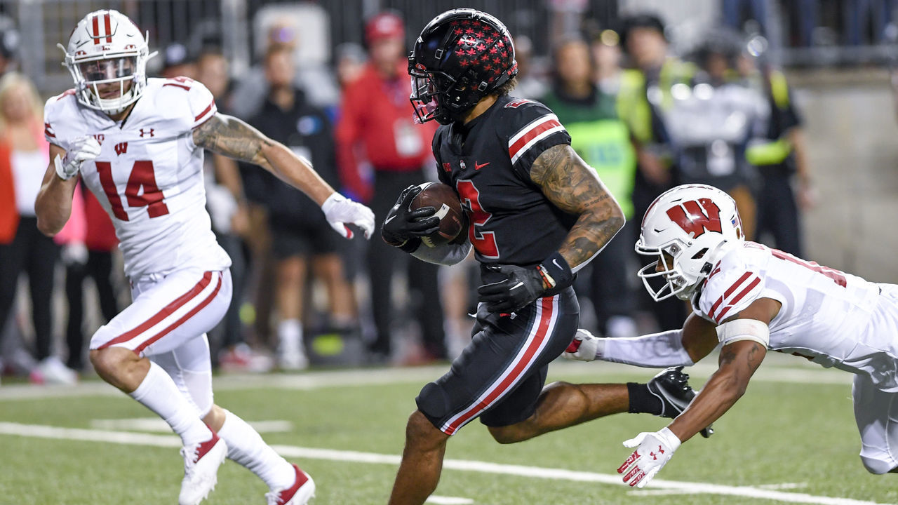 COLUMBUS, OHIO - SEPTEMBER 24: Wide receiver Emeka Egbuka #2 of the Ohio State Buckeyes evades a tackle from cornerback Max Lofy #12 of the Wisconsin Badgers before scoring a touchdown in the fourth quarter at Ohio Stadium on September 24, 2022 in Columbus, Ohio.