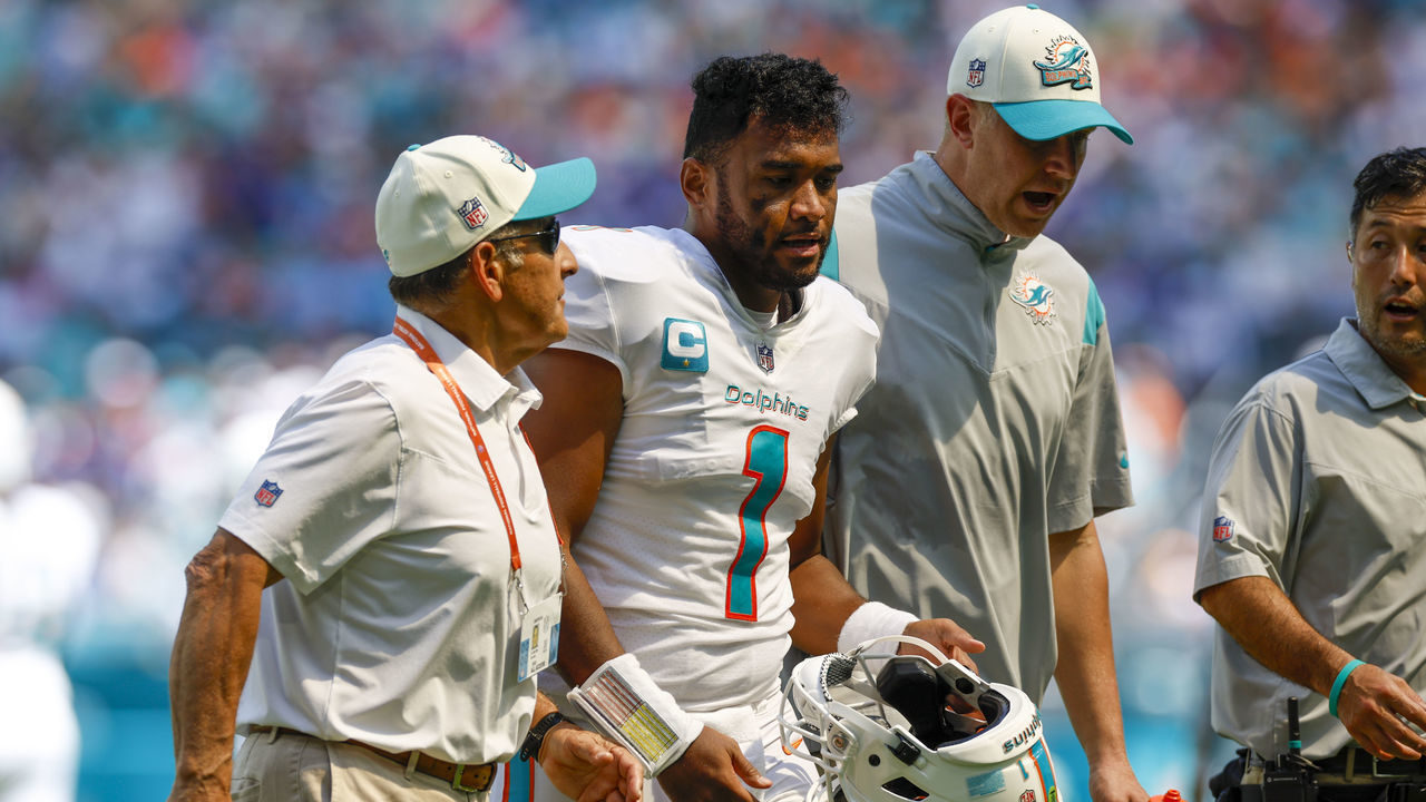 MIAMI GARDENS, FL - SEPTEMBER 25: Miami Dolphins quarterback Tua Tagovailoa (1) walks off the field with trainers following a play during the game between the Buffalo Bills and the Miami Dolphins on September 25, 2022 at Hard Rock Stadium in Miami Gardens, Fl.