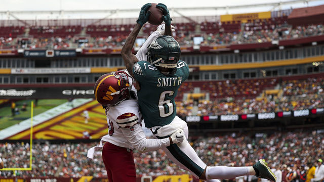 LANDOVER, MARYLAND - SEPTEMBER 25: Wide receiver DeVonta Smith #6 of the Philadelphia Eagles catches a touchdown over cornerback Kendall Fuller #29 of the Washington Commanders during the second quarter at FedExField on September 25, 2022 in Landover, Maryland.
