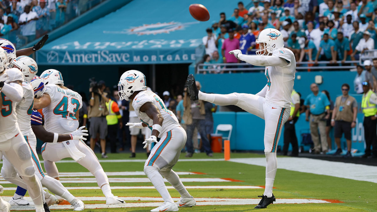 MIAMI GARDENS, FL - SEPTEMBER 25: Miami Dolphins punter Thomas Morstead (4) punts the ball off the backside of Miami Dolphins wide receiver Trent Sherfield (14) for a safety during the game between the Buffalo Bills and the Miami Dolphins on September 25, 2022 at Hard Rock Stadium in Miami Gardens, Fl.