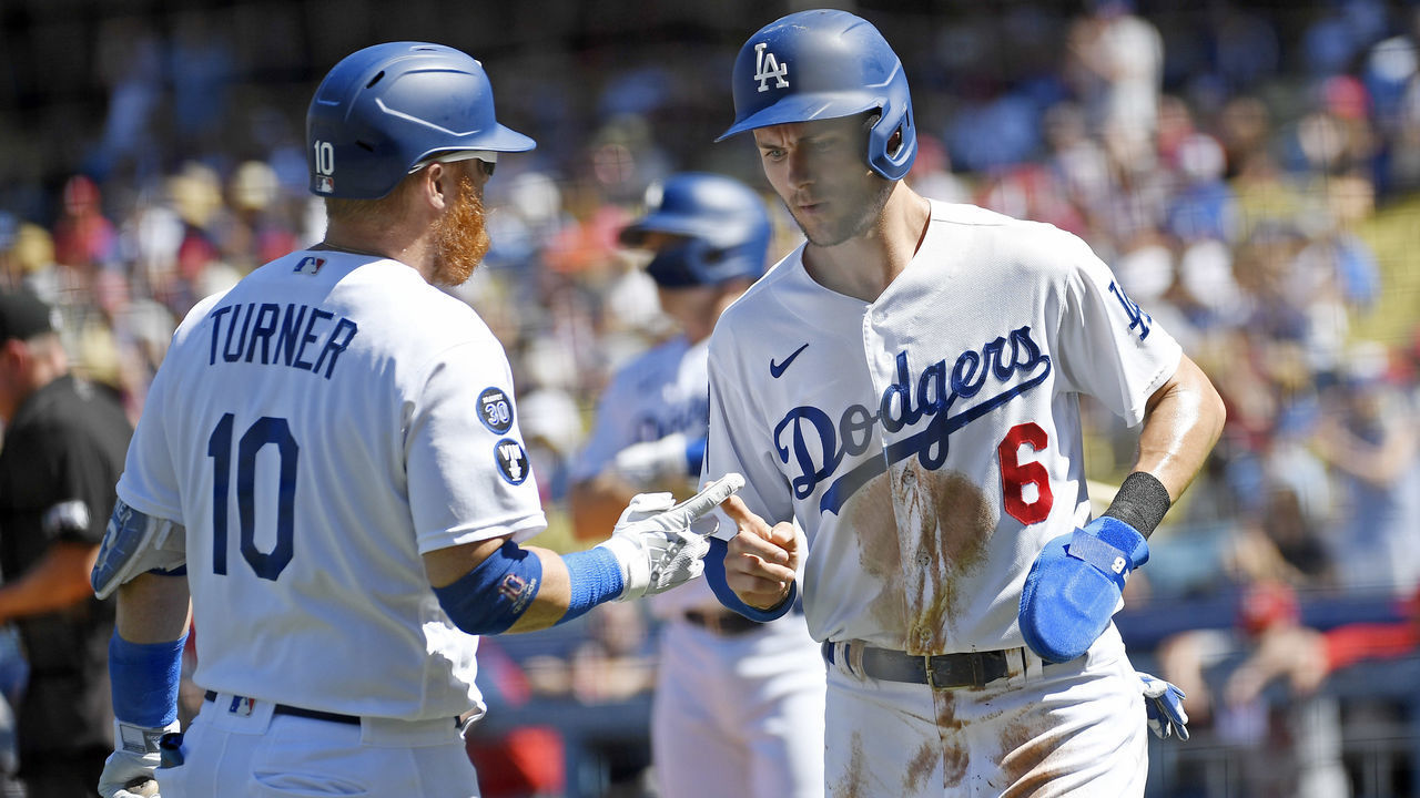 LOS ANGELES, CA - SEPTEMBER 25: Trea Turner #6 of the Los Angeles Dodgers is congratulated by Justin Turner #10 after scoring a run against starting pitcher Adam Wainwright #50 of the St. Louis Cardinals during the first inning at Dodger Stadium on September 25, 2022 in Los Angeles, California.