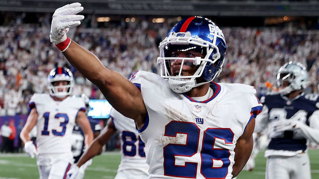 EAST RUTHERFORD, NEW JERSEY - SEPTEMBER 26: Saquon Barkley #26 of the New York Giants celebrates after scoring a 36 yard touchdown against the Dallas Cowboys during the third quarter in the game at MetLife Stadium on September 26, 2022 in East Rutherford, New Jersey.