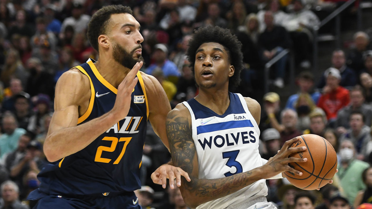 SALT LAKE CITY, UTAH - DECEMBER 23: Jaden McDaniels #3 of the Minnesota Timberwolves drives into Rudy Gobert #27 of the Utah Jazz in the second half of a game at Vivint Smart Home Arena on December 23, 2021 in Salt Lake City, Utah.