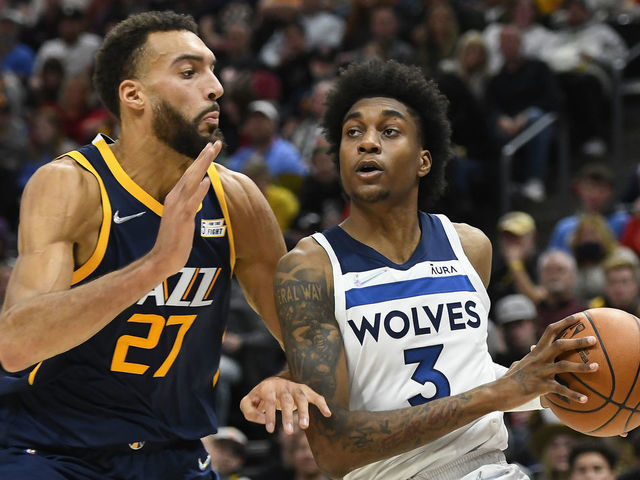 SALT LAKE CITY, UTAH - DECEMBER 23: Jaden McDaniels #3 of the Minnesota Timberwolves drives into Rudy Gobert #27 of the Utah Jazz in the second half of a game at Vivint Smart Home Arena on December 23, 2021 in Salt Lake City, Utah.