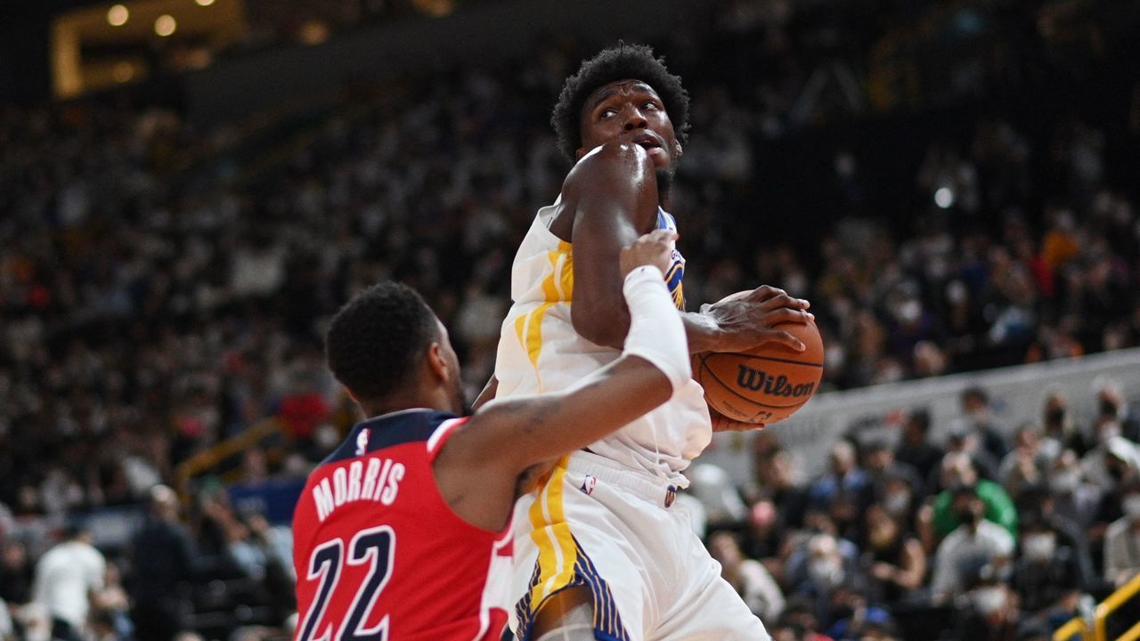 Golden State Warriors' James Wiseman (R) goes for the basket past Washington Wizards Monte Morris (L) fight for the ball during the NBA Japan Games 2022 pre-season basketball game between the Golden State Warriors and the Washington Wizards at the Saitama Super Arena in Saitama on September 30, 2022.