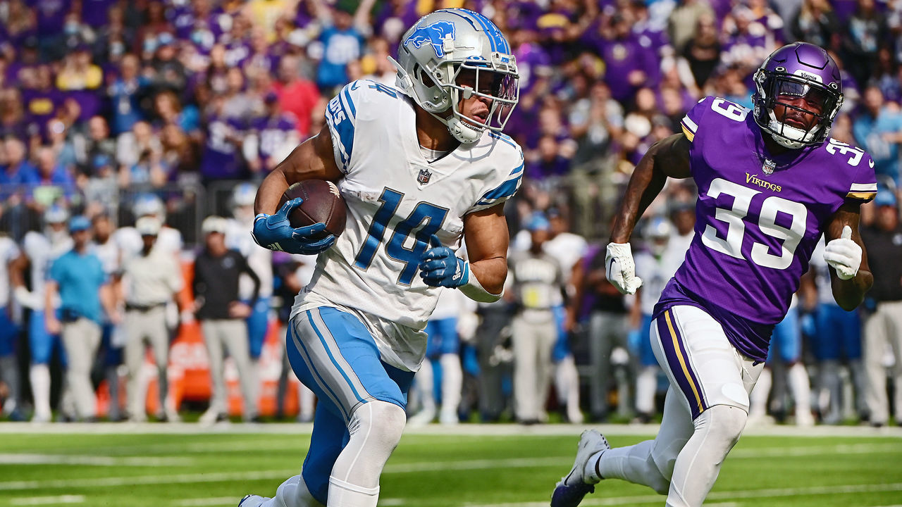MINNEAPOLIS, MINNESOTA - SEPTEMBER 25: Wide receiver Amon-Ra St. Brown #14 of the Detroit Lions runs with the ball as cornerback Chandon Sullivan #39 of the Minnesota Vikings gives chase during the first quarter of the game at U.S. Bank Stadium on September 25, 2022 in Minneapolis, Minnesota.