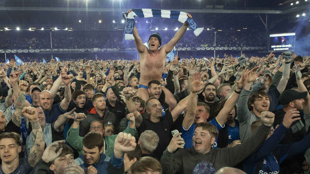 LIVERPOOL, ENGLAND - MAY 19: Everton fan Speedo Mick holds his scarf aloft as fans invade the pitch invade the pitch after the Premier League match between Everton and Crystal Palace at Goodison Park on May 19, 2022 in Liverpool, United Kingdom.