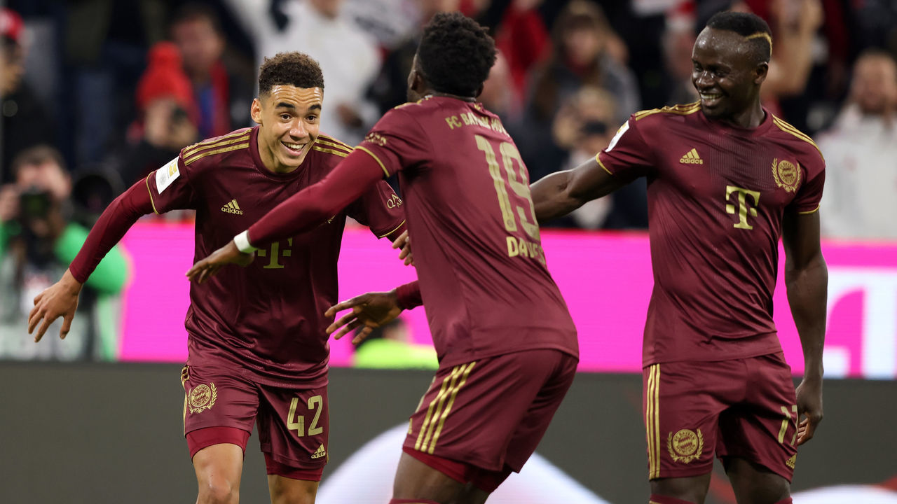 MUNICH, GERMANY - SEPTEMBER 30: Jamal Musiala of Bayern Muenchen celebrates as he scores the goal with Alphonso Davies of Bayern Muenchen and Sadio Mane of Bayern Muenchen during the Bundesliga match between FC Bayern München and Bayer 04 Leverkusen at Allianz Arena on September 30, 2022 in Munich, Germany.