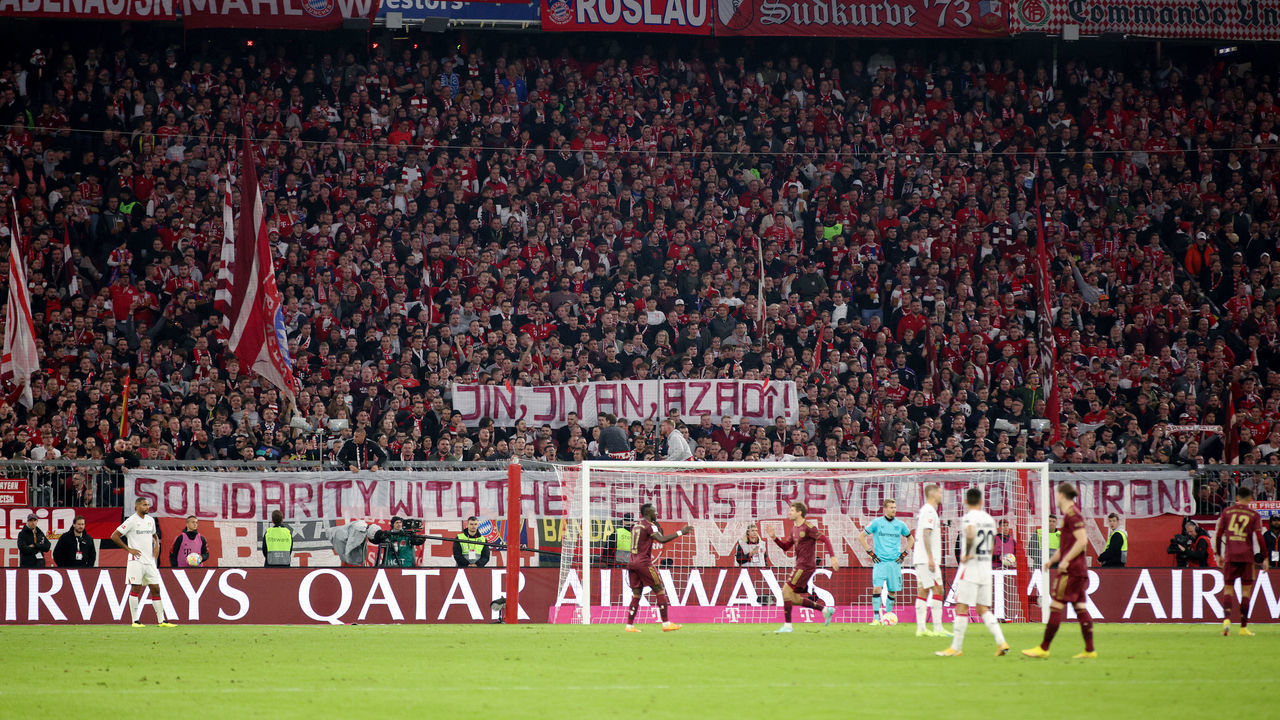 MUNICH, GERMANY - SEPTEMBER 30: Fans of Bayern Munich hold up a banner which reads 'Solidarity With The Feminist Revolution In Iran' during the Bundesliga match between FC Bayern München and Bayer 04 Leverkusen at Allianz Arena on September 30, 2022 in Munich, Germany.